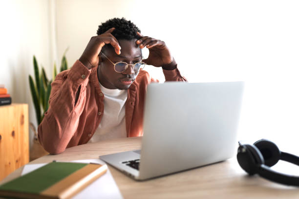student making helb loan application on laptop